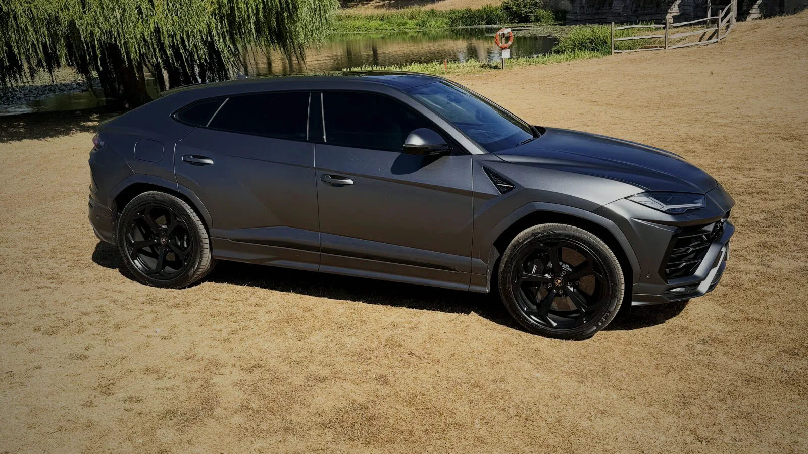 Side profile of the satin grey Lamborghini Urus wedding car on a driveway
